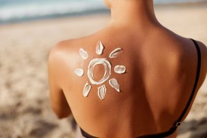 sunscreen on womans back